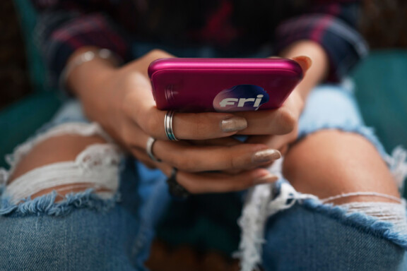 The,Hands,Of,A,Young,Woman,Wearing,Ripped,Jeans,Holding